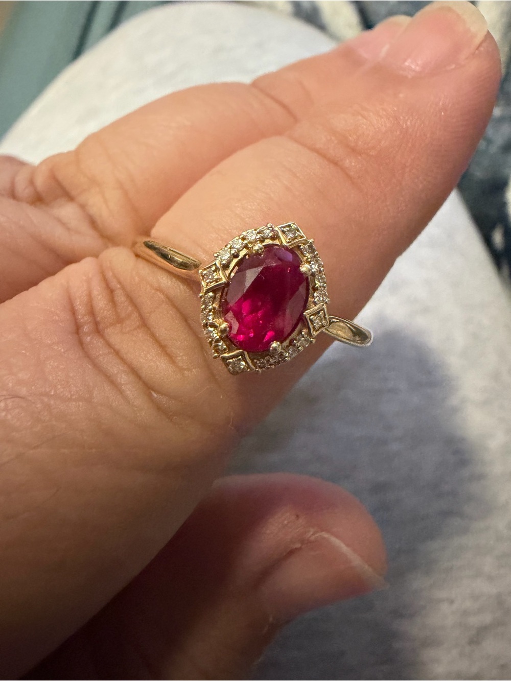 Oval Cut Created Ruby and Diamond Halo Ring in 10kt Yellow Gold